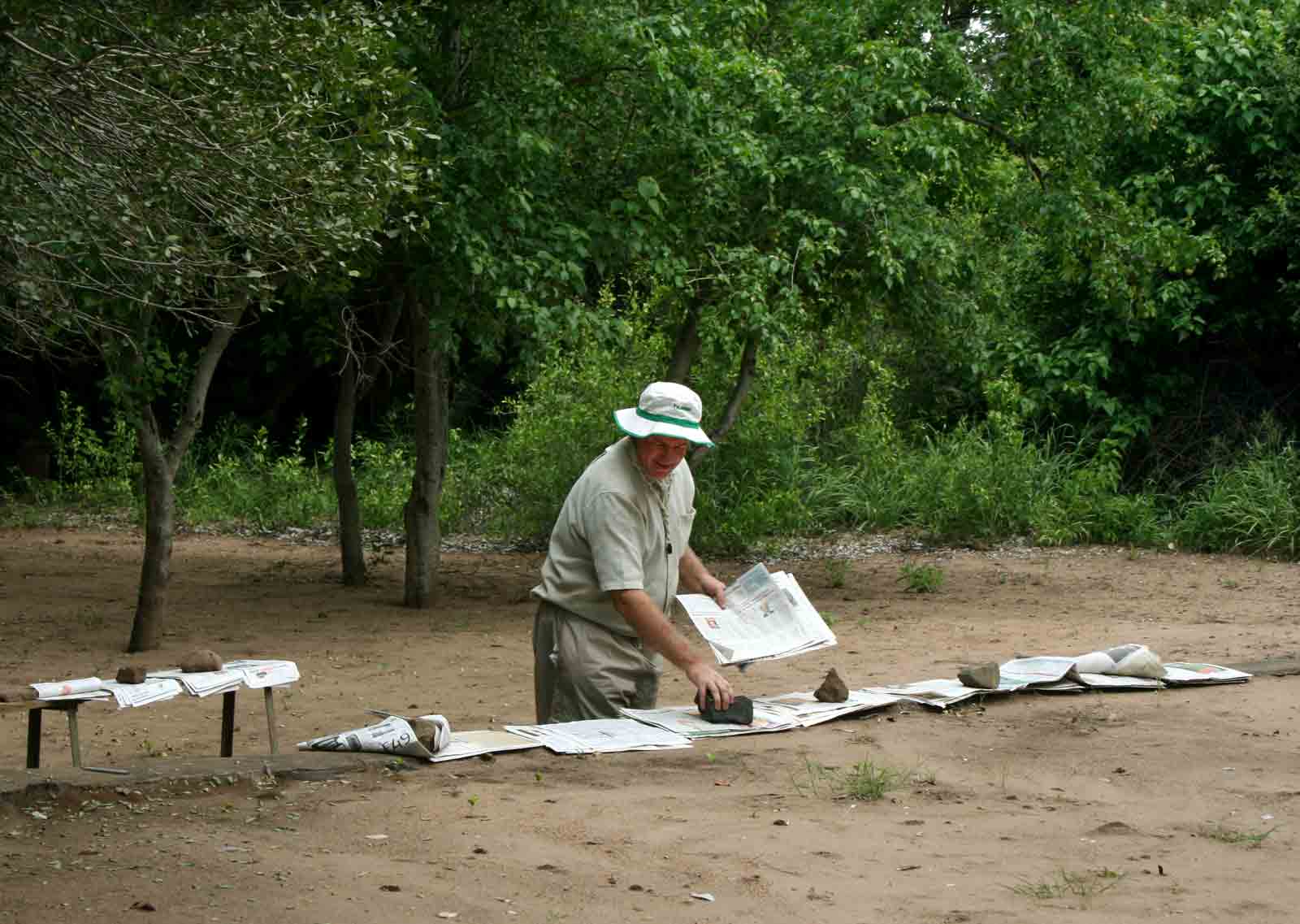 Mark Hyde attempting to dry newspaper one rather cloudy day at the Shashe Wilderness Camp.